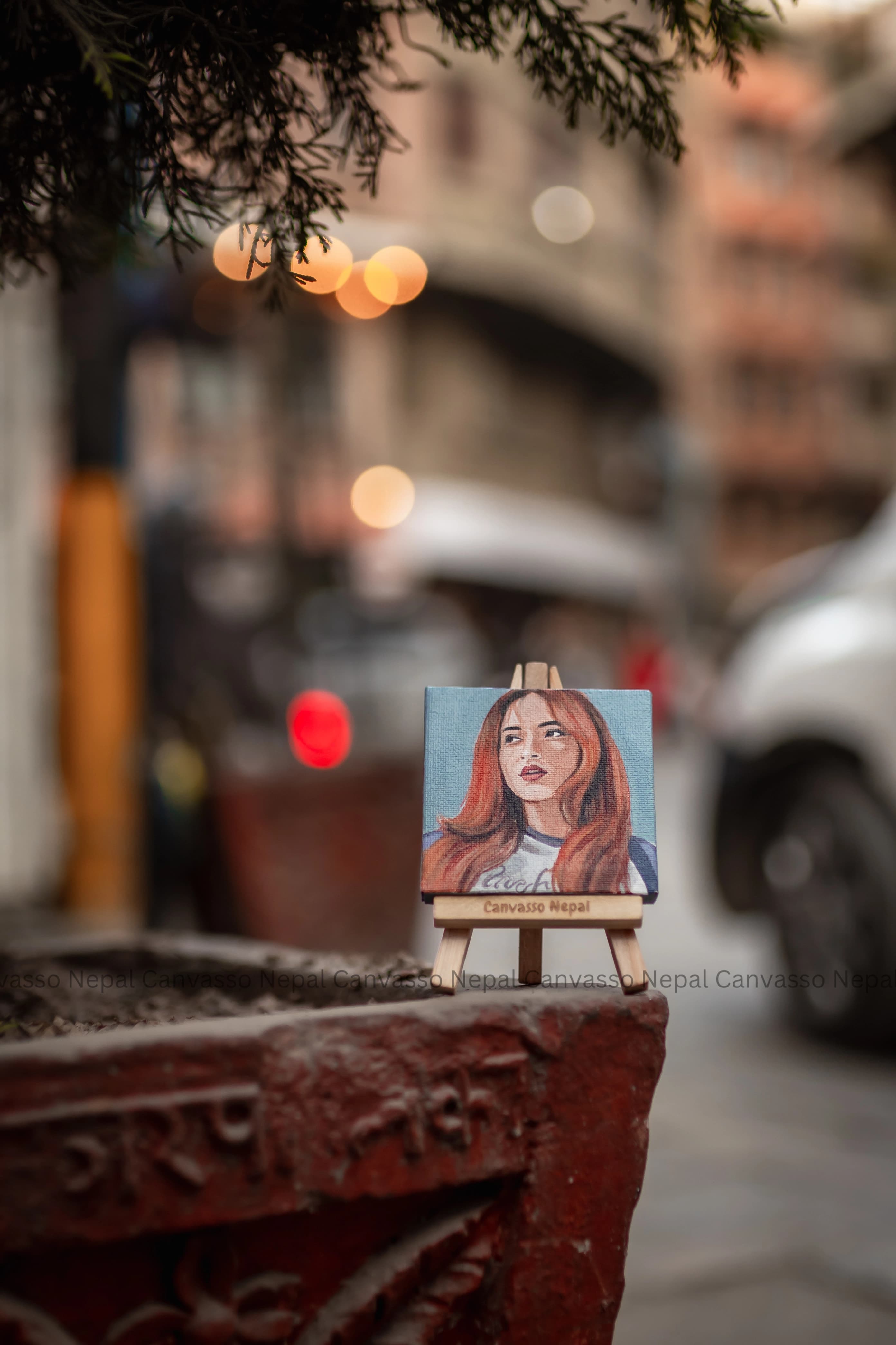 Compact hand-painted portrait kept on a display easel